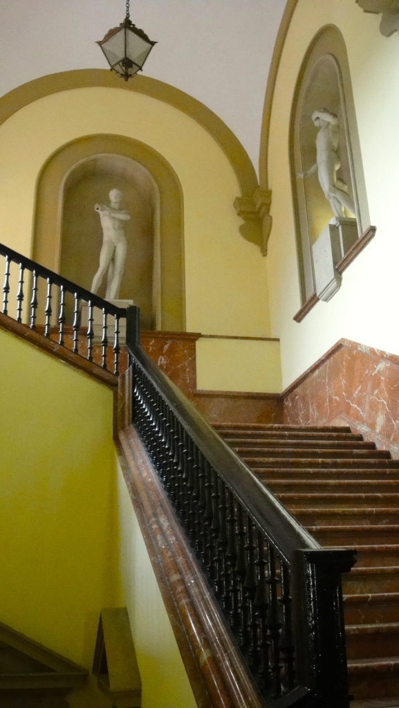 One of the staircases, and casual classic statues.